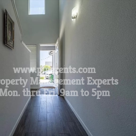 a long hallway with a window and a door
