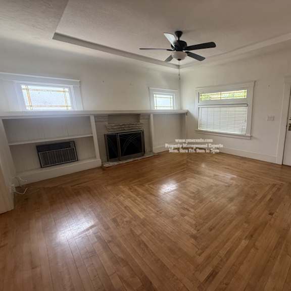 a room with a wooden floor and a ceiling fan.