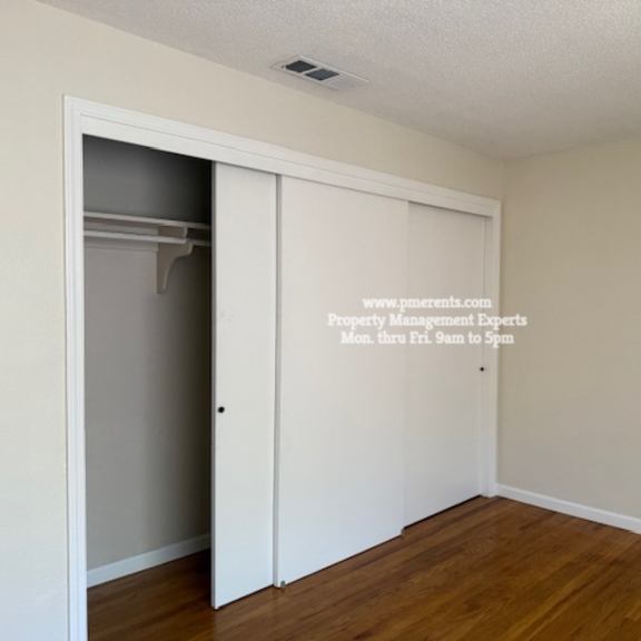 a room with a white door and a white wall with a website address on it.