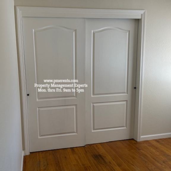 a white door with a glass panel and a website address on it.