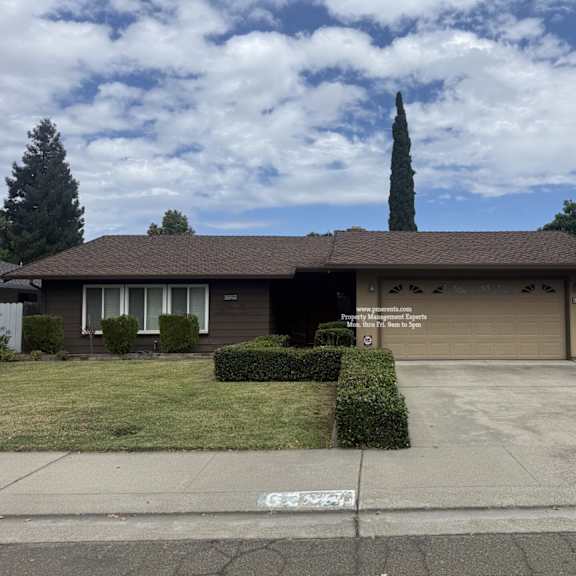 a house with a brown roof and a garage door.