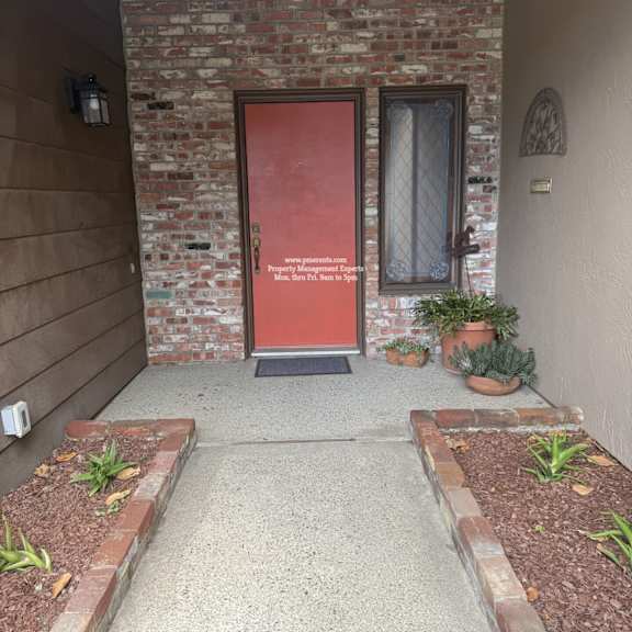 a red door with a glass window and a sign on it.