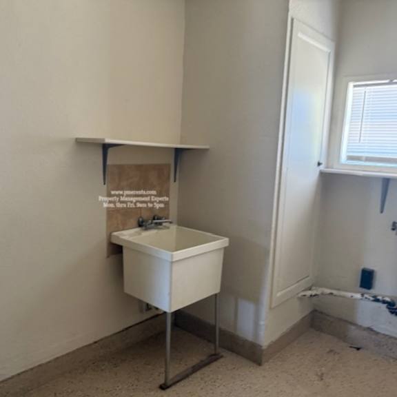 a white cabinet with a sign on it in a room with white walls.