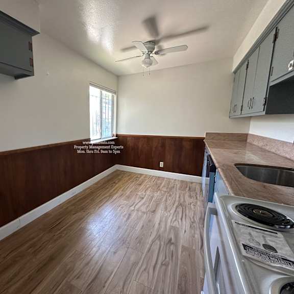 a kitchen with wooden floors and a window.