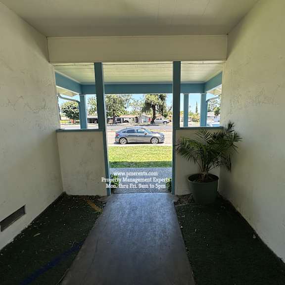 a sign in the window of a building advertises property management services.