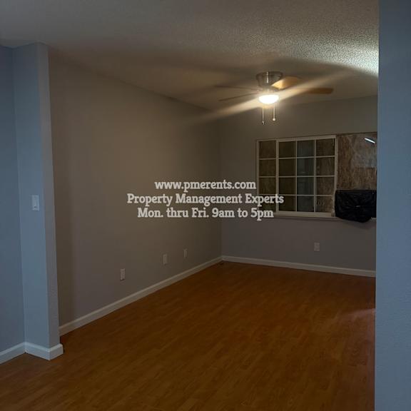 a room with a wooden floor and a ceiling fan.