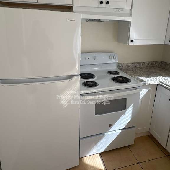 a white fridge and stove in a kitchen.