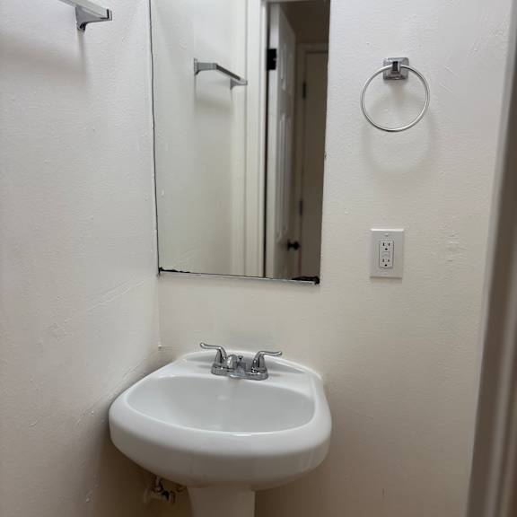 a white sink in a small bathroom.