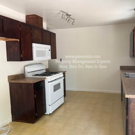a kitchen with a stove, microwave, and oven.