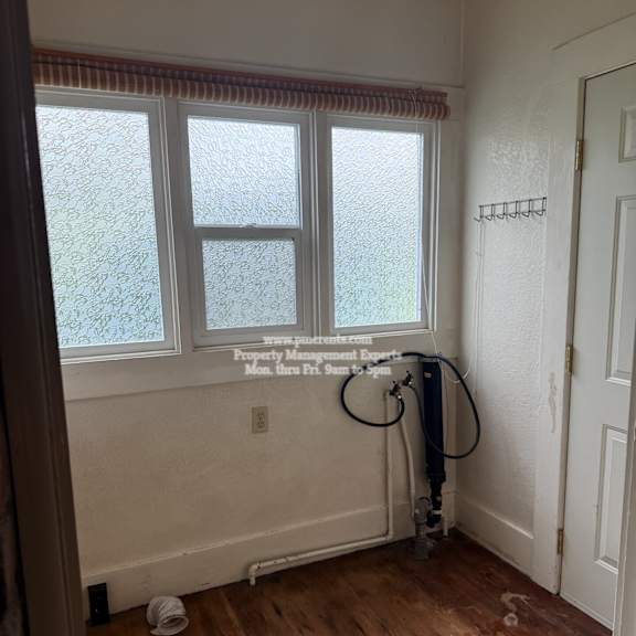 a room with a vacuum cleaner and a window.