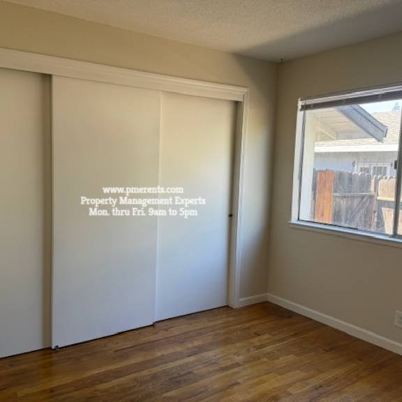 a room with a sliding door and a window.