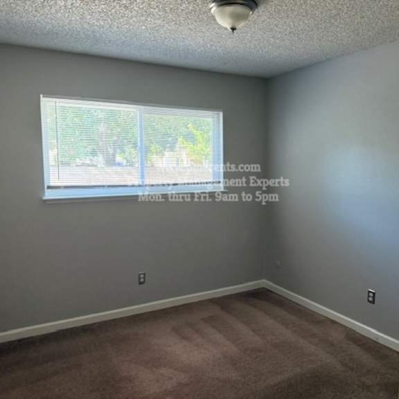 a room with a window and a car parked outside.