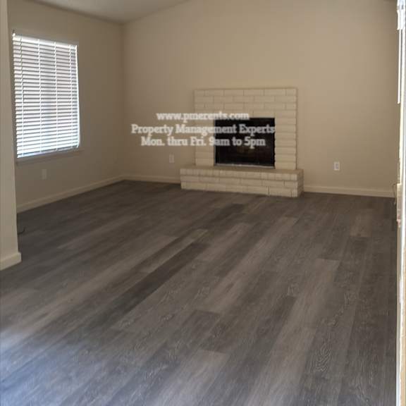 a room with a wooden floor and a sign on the wall.