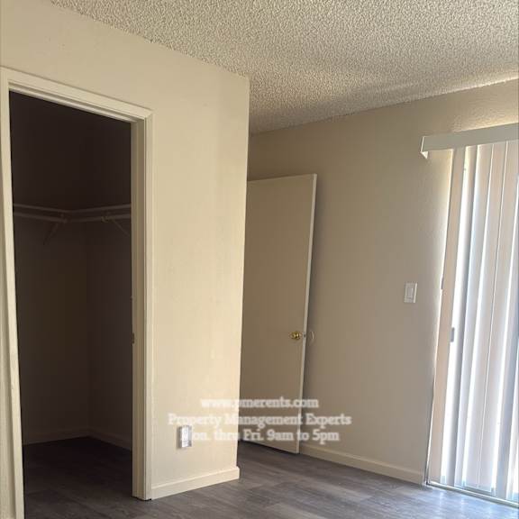 a room with a grey floor and a white door.