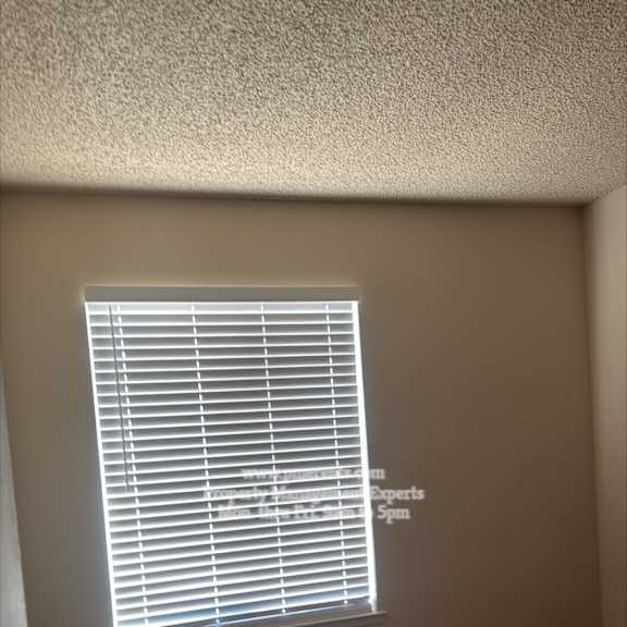 a room with a closed door and a window with blinds.