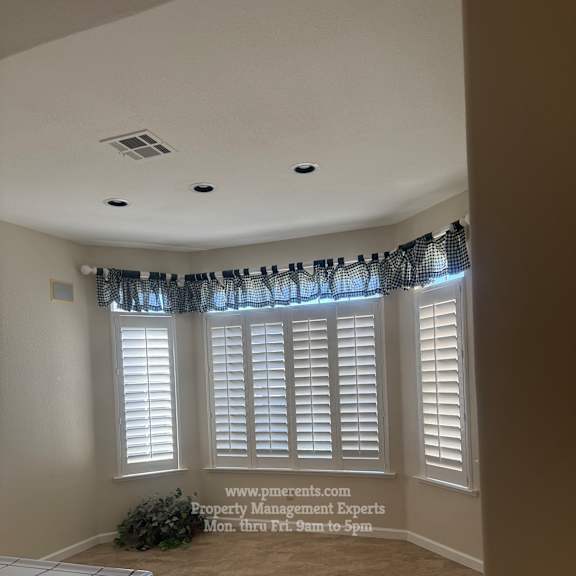 a room with a window covered by a black curtain.