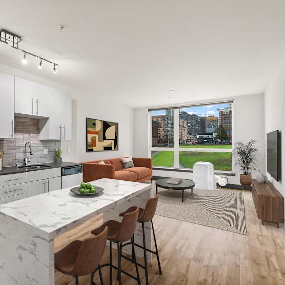A modern kitchen with a large island and a view of the city.