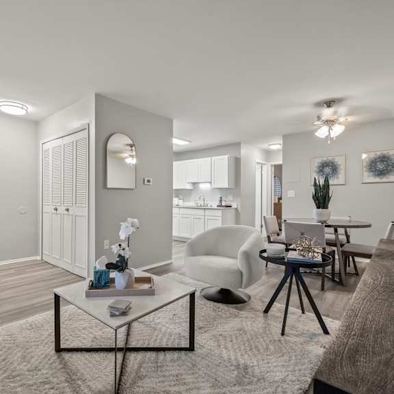 a modern living room with a grey carpet and white walls.