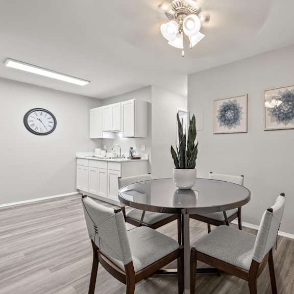 a dining room with a round table and chairs.