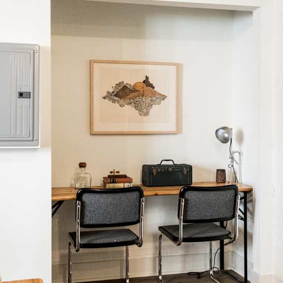 a room with a desk and two chairs.