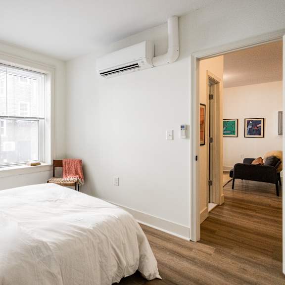 a bedroom with a large bed and a window.
