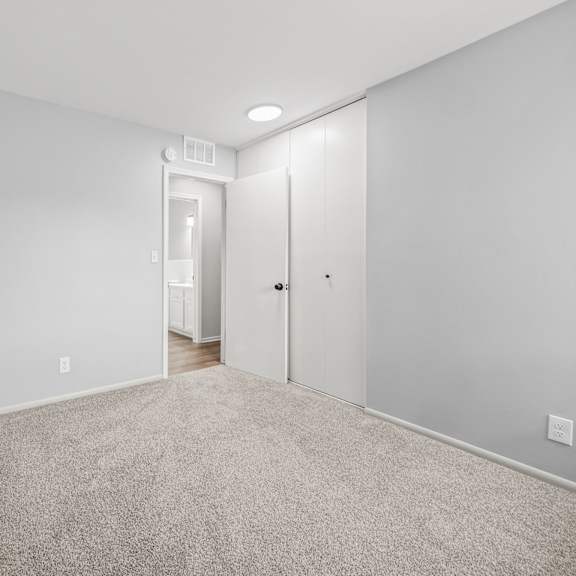 a master bedroom with gray walls and a carpeted floor