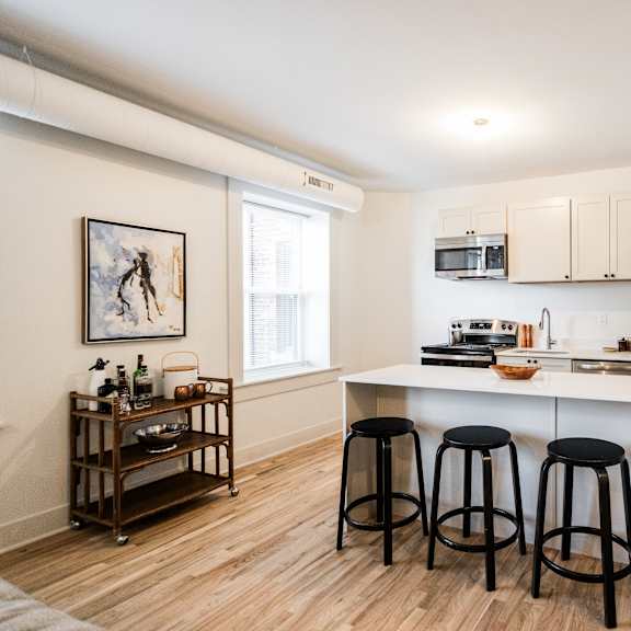 a kitchen with white cabinets and a white counter top.