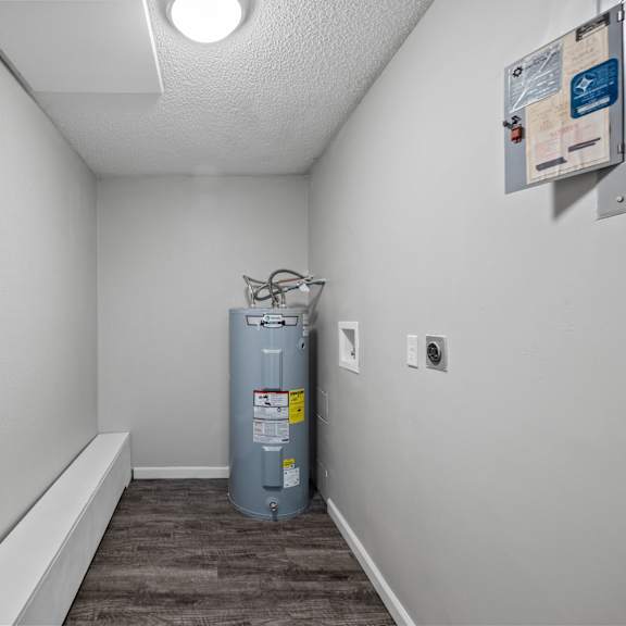 a room with a boiler and a water heater in it