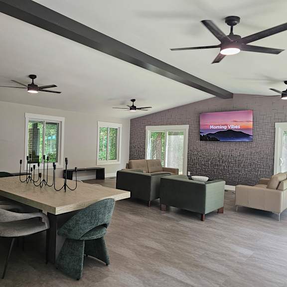 a modern living room with a large table and chairs.