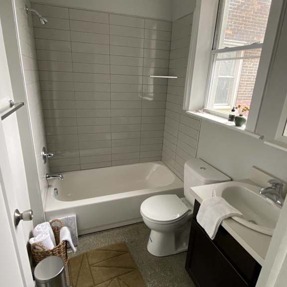 a bathroom with a toilet and a tub and a sink