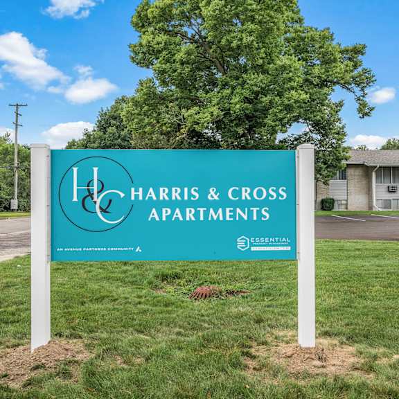 a sign in front of a building that says harris & cross apartments