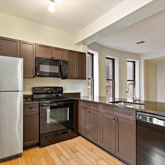a kitchen with wooden cabinets and stainless steel appliances