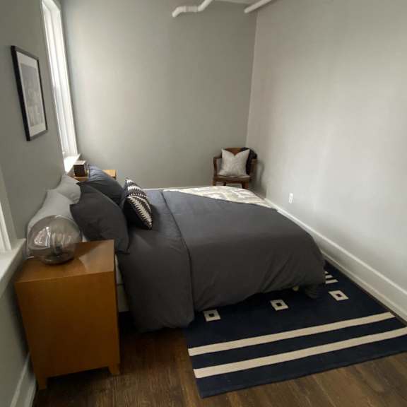 a bedroom with a bed and a window