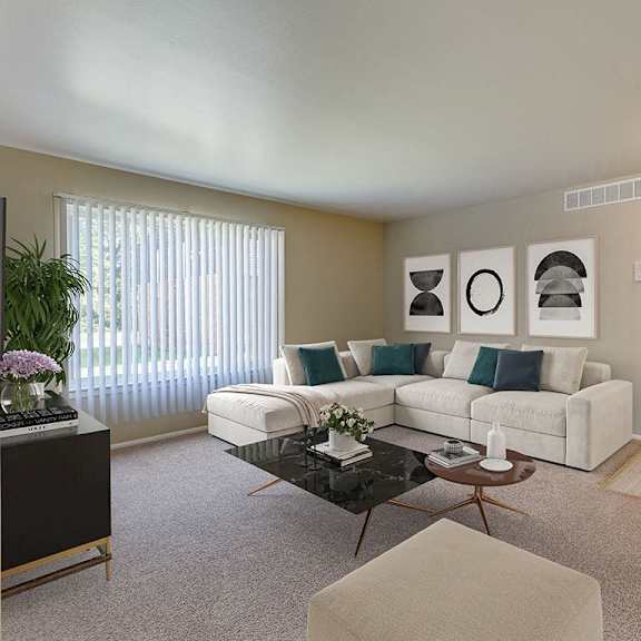 a living room with a white couch, a coffee table, and a potted plant.