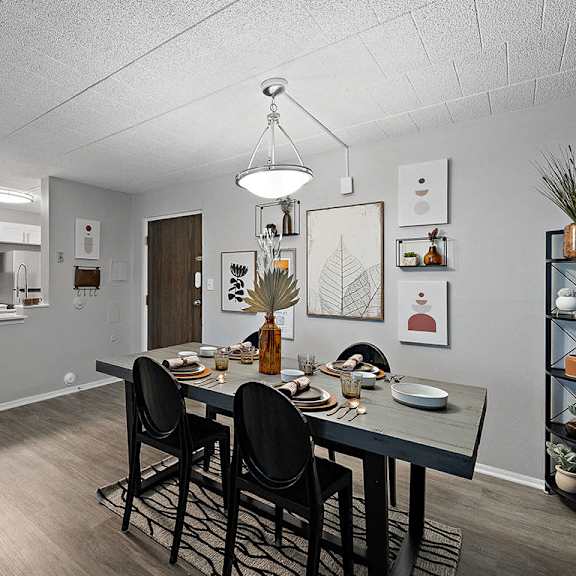 a dining room with a table set for four.