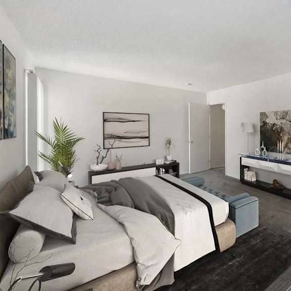 a bedroom with a large bed and a bench.
