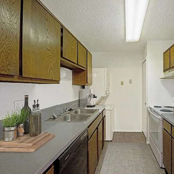 a kitchen with wooden cabinets and a white refrigerator.