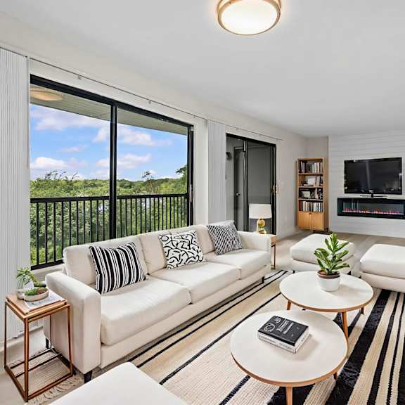 a living room with a white couch and a coffee table.