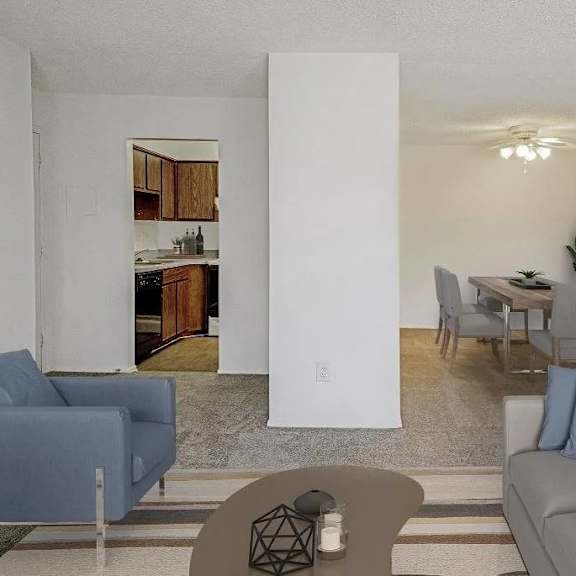 a living room with a grey couch and a blue chair.