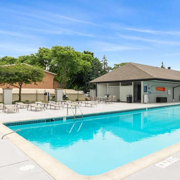 a large swimming pool with a building in the background.