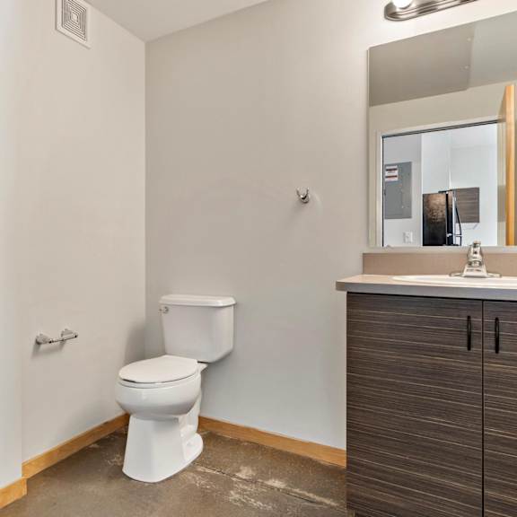 a bathroom with a toilet sink and shower