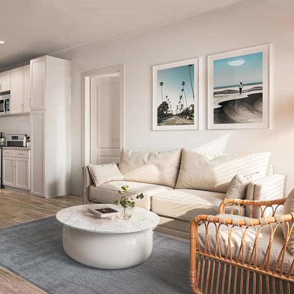 Thumbnail 4 of 4 A modern living room with a kitchen area in the background at Allegra at Cocoa in Cocoa, FL, 32926