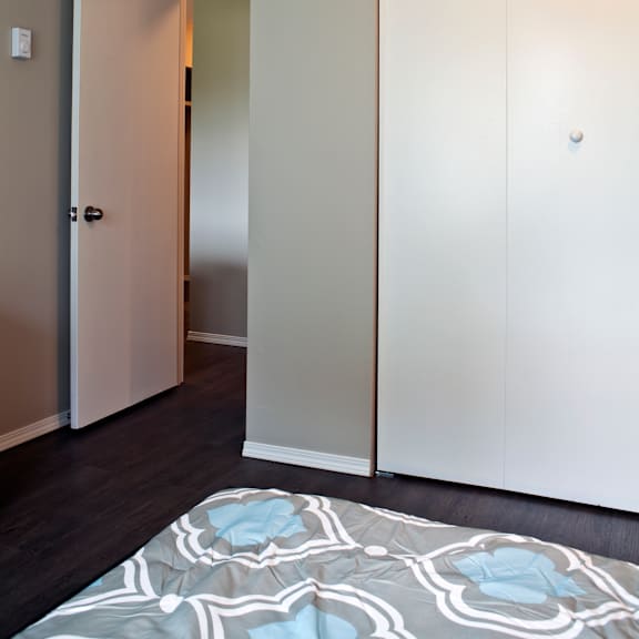 a white door is open to a hallway.