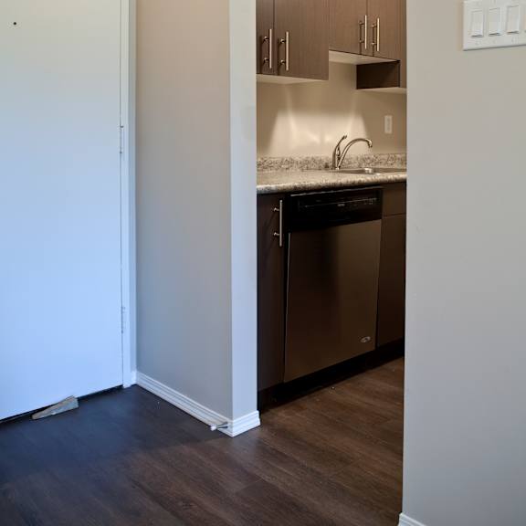 a kitchen with a white door and a white light switch.