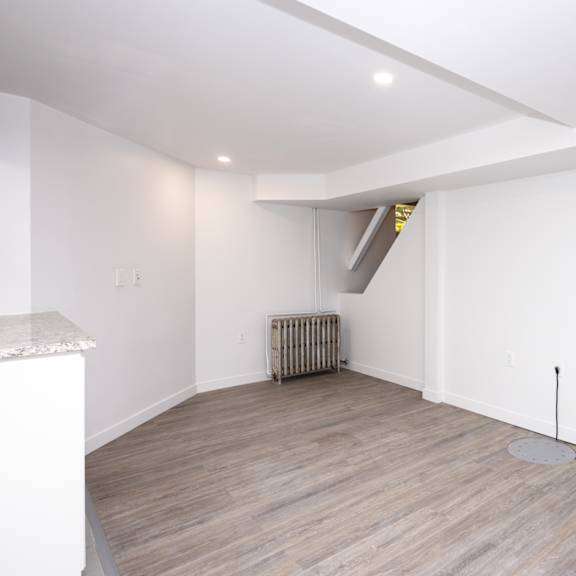 a room with a white ceiling and a radiator on the floor.