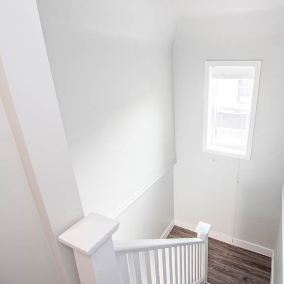 a small white room with a small window