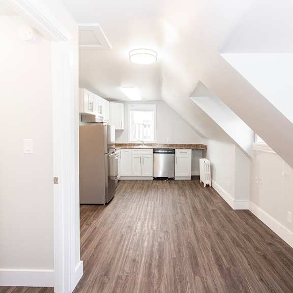 a kitchen and living room in an attic
