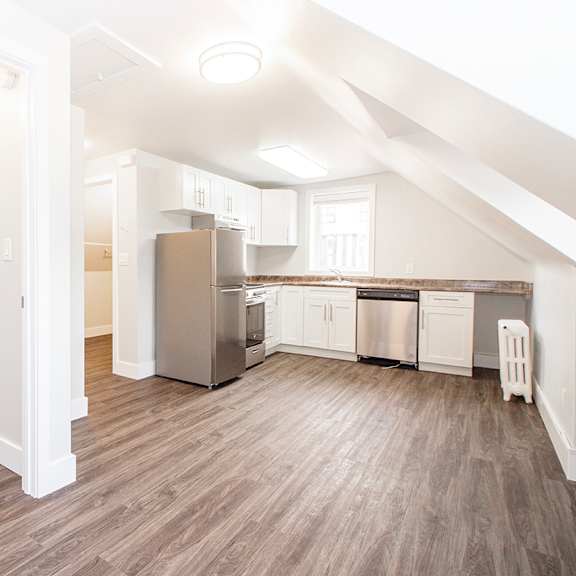a kitchen and living room in an attic
