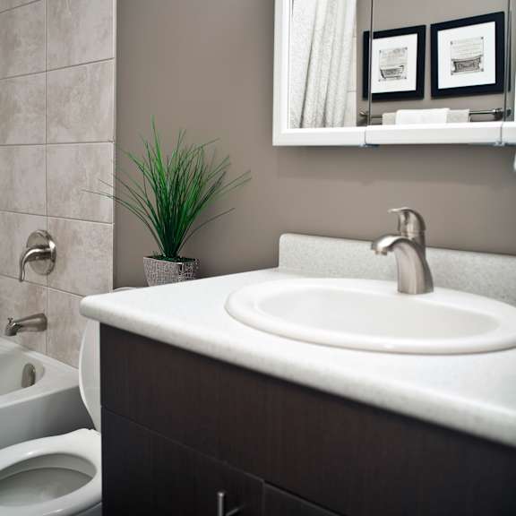 a bathroom with a white sink and a toilet.