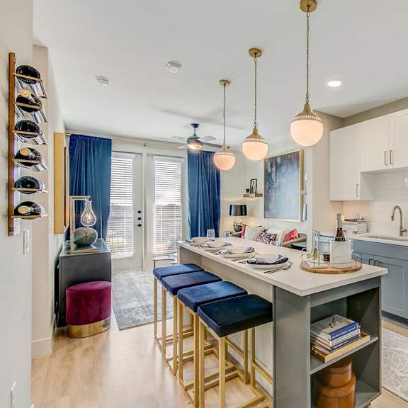 a kitchen with a white countertop and a stainless steel oven.